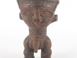 an old wooden statue of a man with a hat on his head