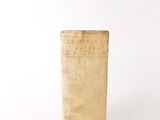 an old book sitting on top of a wooden table