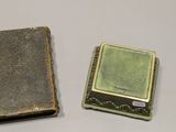 two pieces of metal on a white surface