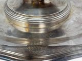 a silver plate with a bowl on top of it