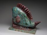 a sculpture of a fish that is sitting on top of a table