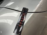 a close up of a measuring tape on a car ' s hood