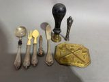 a lot of silverware on a table with a spoon and fork