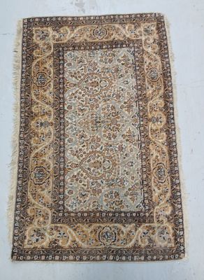 a rug on a white floor with a brown border
