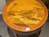 a wooden table with a painting on it in a room