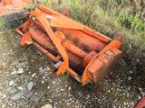 a rusted orange machine that is sitting on the ground