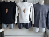 three mannequins and three shirts on display in a store