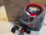a vacuum that is sitting on the floor next to a box