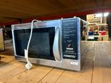 un micro-ondes posé sur une table dans une pièce