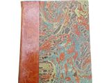 an image of a leather journal with a paisley design on the cover