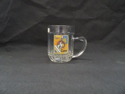 a glass mug that has a picture of a man on it