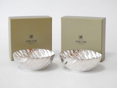 two silver bowls sitting next to each other in front of a box