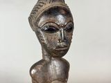 a close up of a statue of a person wearing a hat
