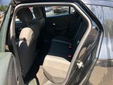 the back seat of a car with the door open in a parking lot