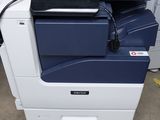 a printer that is sitting on top of a pile of papers