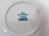 a close up of a white plate with a green logo on it