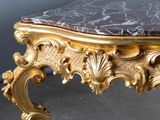 a gold table with a marble top on it
