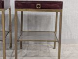 pair of brass and leather side tables with drawers on each side