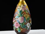 a vase with a floral design on it on a table