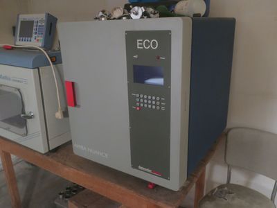 two microwaves that are sitting on a table in a room
