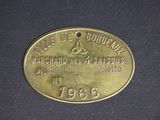 an old brass plate with the name of a man on it