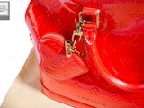 a red purse sitting on top of a table