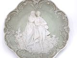 a white plate with a picture of a man and a woman on it