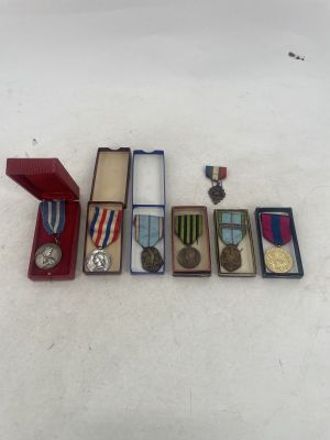 several medals and medals are arranged in a row on a white surface