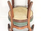 a wooden rocking chair with a green seat on a white background