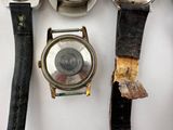 a watch that is sitting on a table next to other watches