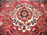 an image of a red rug with a medallion design on it