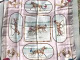 a picture of a table cloth with a picture of horses and jockeys on it