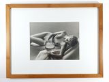 black and white photograph of a woman laying in bed with her head on a pillow
