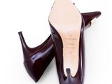 pair of women ' s shoes on a white surface with a white background