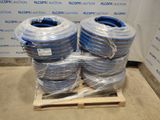 two bundles of blue and white hoses sitting on a pallet in front of a wall