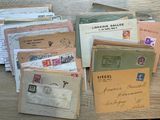 a pile of old letters and envelopes sitting on a table