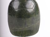 sculpture of a green stone sphere on a wooden base