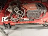 une boîte rouge sur laquelle sont posés une perceuse et d'autres outils