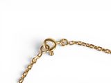 the gold chain bracelet has a heart charm on it