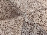 a close up of a cow skin rug on the floor