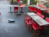 many tables and chairs in the courtyard of a restaurant