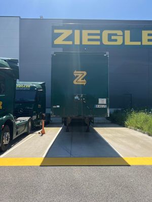two trucks that are parked in front of a building