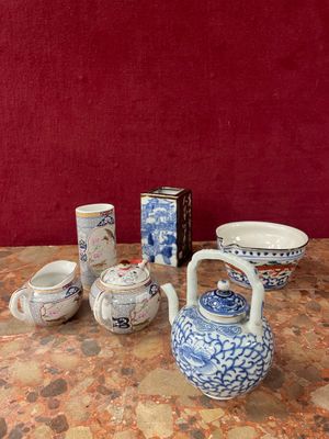 a table with a variety of teapots and bowls on it