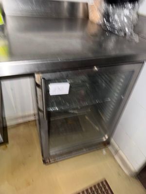 stainless steel counter top in a commercial kitchen with a glass door