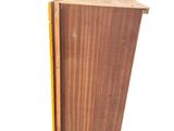 a tall wooden box with a ruler on top of it