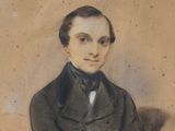 portrait of a man in a suit and tie with his arms crossed