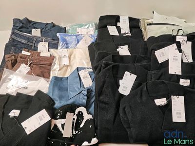 many different types of clothing on display on a table