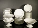 a lot of plates and bowls on the table