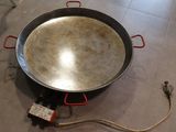 a large pan that is sitting on the floor next to a hose