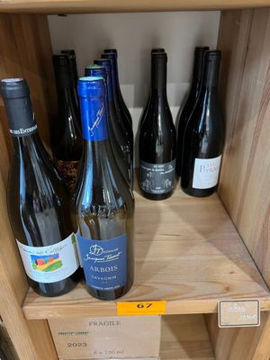 de nombreuses bouteilles de vin sur une étagère dans un magasin
